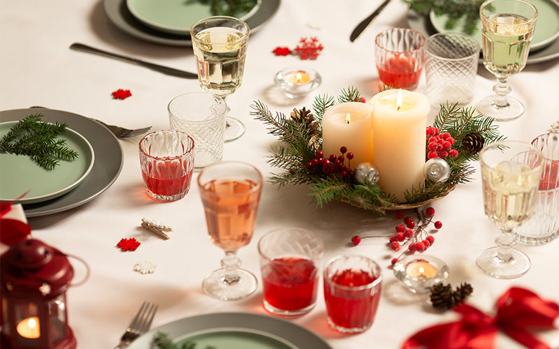 Christmas table setting with floral centrepiece and candles