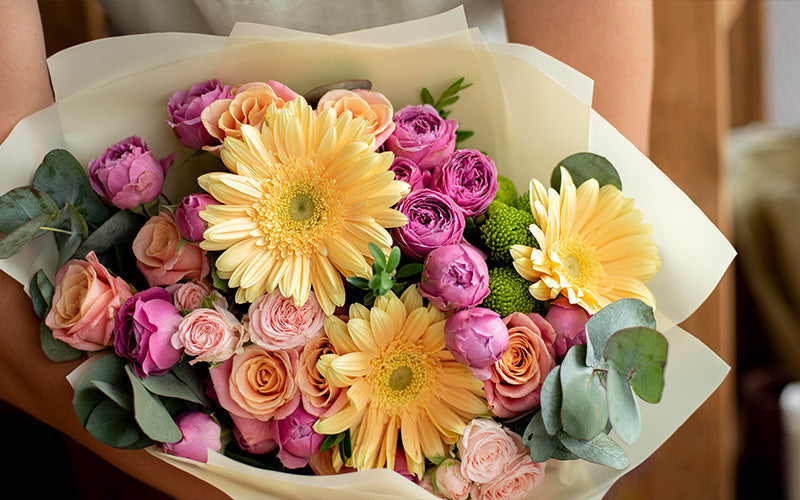 Close-up of a bouquet with pink, orange, and yellow flowers