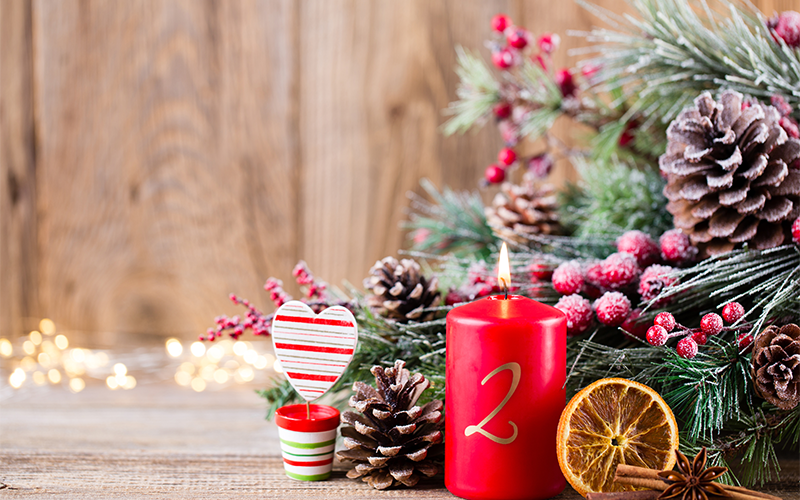 Red Advent candle, pinecones, and evergreen Christmas table decor