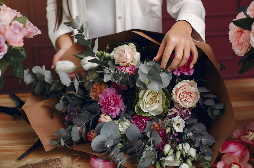 Florist arranging a colorful bouquet to spark creative inspiration.