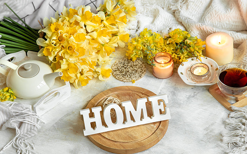 Cozy home scene with flowers and candles.