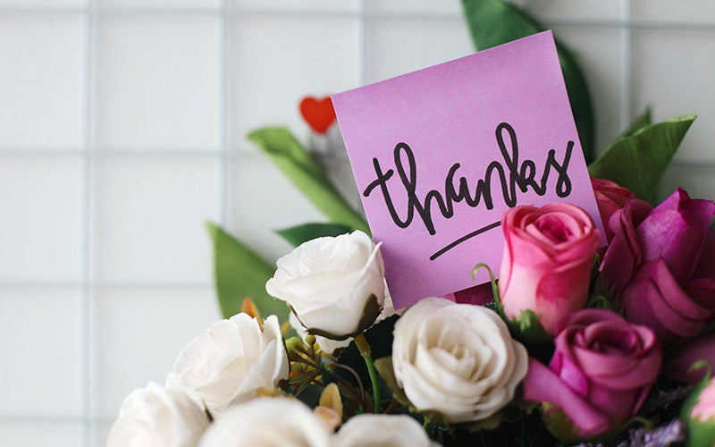 Pink and white roses with a thanks note for friends.